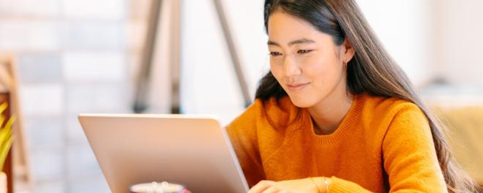 Woman-Smiling-While-Using-a-Laptop