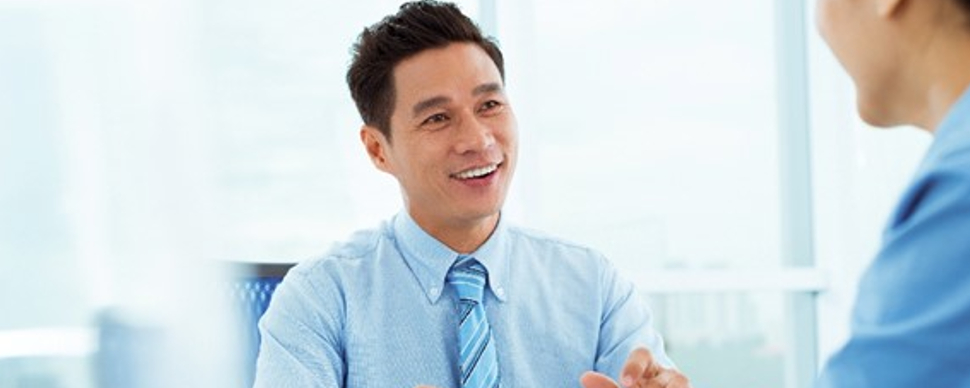 A person in a blue shirt and tie