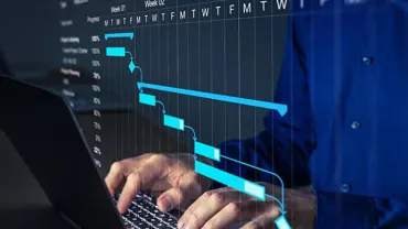 Person typing on laptop with overlay of project management timeline and progress chart.