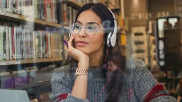 Woman wearing headphones and glasses