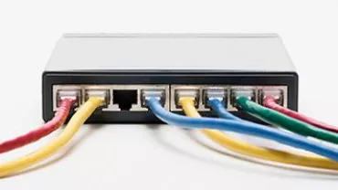 Network switch with colored cables plugged in.